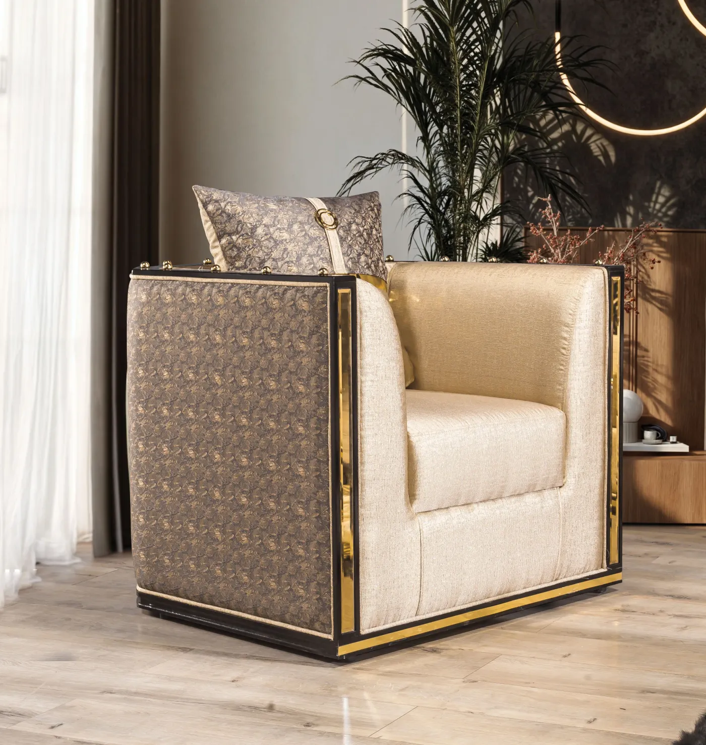 Bentley armchair in cream velvet beside a gold-framed side table