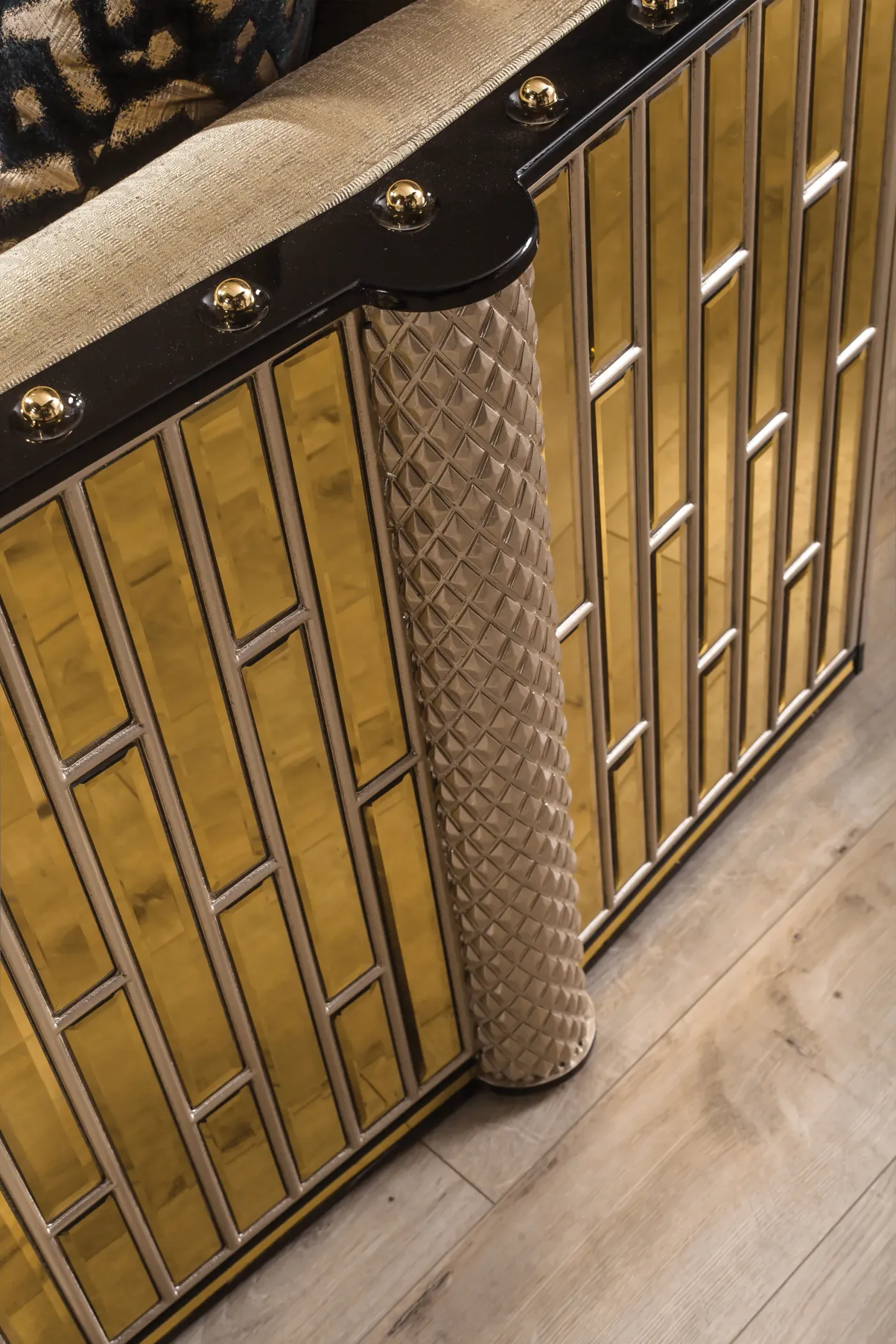 Close-up of the geometric gold column detailing on a Bentley frame