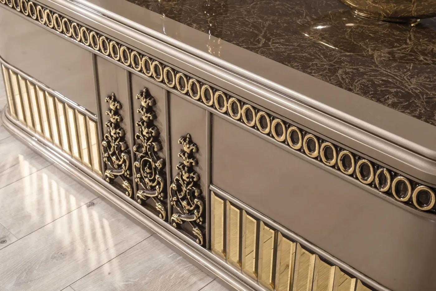 Close-up of the carved gold appliqué on a Gucci frame