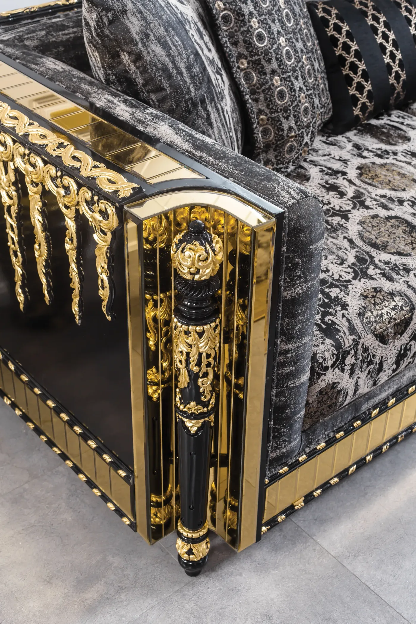 Close-up of the cast gold tassel and column detailing on a Lagos frame